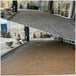 a before and after of pavers outside a hotel in Toronto that were restored during a training session for installing trident hurricane cat 5 two part urethane sealer, offering high gloss and deep colour enhancement. the pavers were also cleaned with effbomb from stonesealer Canada